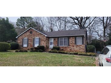 Charming brick home with well-maintained lawn and classic architectural details at 425 Whitethorn Dr, Gastonia, NC 28054