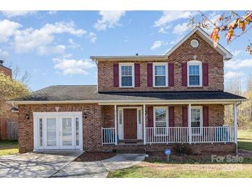 Charming two-story brick home with a well-maintained front yard and covered porch at 4405 Ashton Ct, Indian Trail, NC 28079
