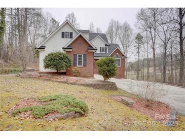 Charming two-story home with a brick facade, white siding, and landscaped front yard at 5306 Club View Dr, Concord, NC 28025
