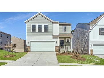 Charming two-story home with a two-car garage and well-maintained lawn at 10115 Chatham Run Ln, Charlotte, NC 28262