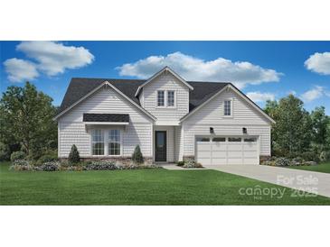 Charming single-Gathering home featuring white siding, a two-car garage, and professionally landscaped front yard at 1012 Pinecone Ave # 134, Indian Land, SC 29707