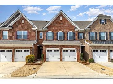 Charming brick townhouse with two-car garage and well-maintained landscaping at 105 Burlingame Ct # B, Mooresville, NC 28117