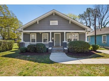 Charming home with a well-manicured lawn, quaint front porch, and beautiful curb appeal at 1105 Vanizer St, Charlotte, NC 28208