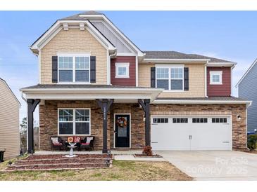 Charming two-story home with stone accents, covered porch, and a two-car garage at 12614 Chantrey Way, Huntersville, NC 28078
