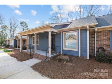 Inviting townhome exterior showcasing a covered front porch, brick foundation, and well-maintained landscaping at 234 Pointe Cir, Rock Hill, SC 29732