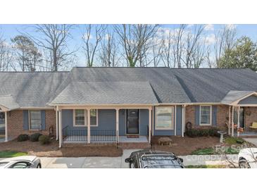 Charming single-story townhome features a cozy front porch, brick accents, and inviting curb appeal at 234 Pointe Cir, Rock Hill, SC 29732