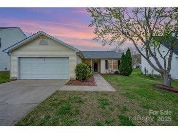 Charming one-story home with attached garage, tidy lawn and mature tree in established neighborhood at 10130 Illoria Dr, Charlotte, NC 28273