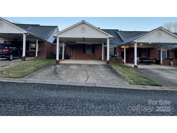 Street view of homes featuring carports, brick facade, and tidy yards at 19915 Oak Leaf Cir, Cornelius, NC 28031