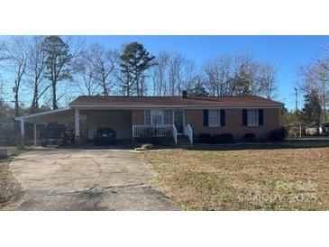 Charming brick ranch home featuring a convenient carport and a well-maintained front yard at 2458 Morningside Dr, Lancaster, SC 29720