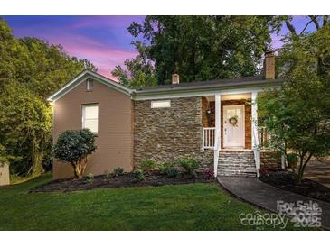 Charming single-story home with stone accents, manicured lawn, and inviting front porch at 4010 Hiddenbrook Dr, Charlotte, NC 28205