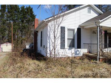 Quaint home featuring white siding, black shutters and a classic brick chimney at 438 Pop Davis Rd, Taylorsville, NC 28681