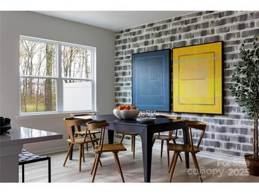 Bright dining room with modern decor, featuring a stylish table and chairs near a window at 7004 Matz Way, Charlotte, NC 28269