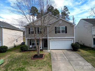 Charming two-story home featuring a well-manicured lawn and a convenient two-car garage at 10114 Turkey Point Dr, Charlotte, NC 28214