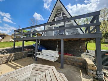 Exterior view of the home with a swing and deck, offering a tranquil and inviting outdoor space at 120 Ole Point Ln, Salisbury, NC 28146