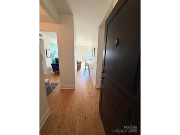 Inviting entryway with hardwood floors, leading to the living and dining areas for a seamless transition at 1315 East Blvd # 328, Charlotte, NC 28203