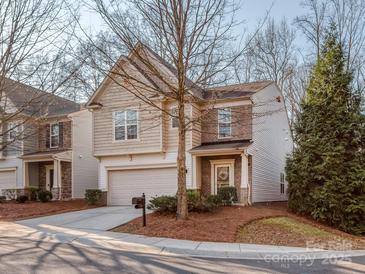 Charming two-story home featuring brick and siding, a well-manicured lawn, and an attached garage at 1708 Royal Gorge Ave, Charlotte, NC 28210