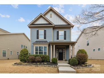 Charming two-story home boasts manicured landscaping and classic architectural details at 1710 Woodward Ave, Charlotte, NC 28206