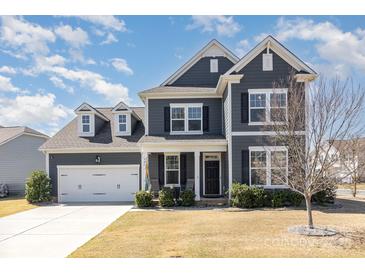 Charming two-story home with gray siding, white trim, and well-manicured landscaping at 3002 Paddington Dr, Indian Trail, NC 28079