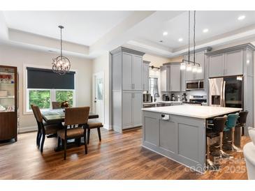 Charming dining area with modern chandelier, wooden table and lots of natural light at 4808 1St Nw St, Hickory, NC 28601