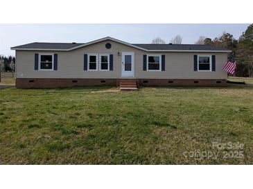 Charming single-story home with light-colored siding, blue shutters, and a well-maintained lawn at 7051 Maple Glen Dr, Catawba, NC 28609