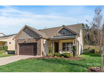 Charming single-Gathering home featuring stone accents, a two-car garage, and a well-maintained lawn at 7127 Hanging Rock Ct, Denver, NC 28037