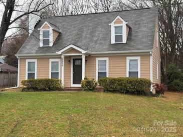 Charming home featuring dormer windows, neutral siding, well-maintained landscaping and a manicured lawn at 7310 Yorkville Ct, Charlotte, NC 28273