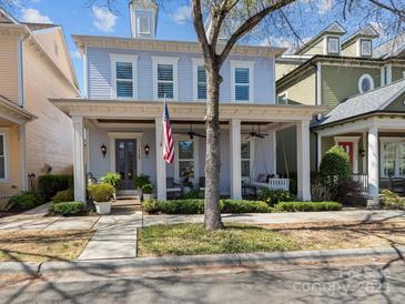Charming two-story home with a welcoming front porch, swing, and an American flag displayed at 1158 South S St, Cornelius, NC 28031