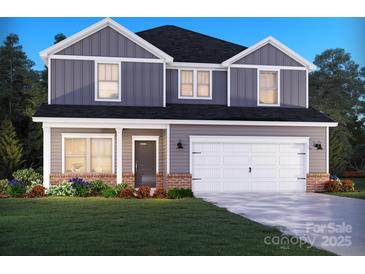 Charming two-story home with a two-car garage, complemented by manicured landscaping and a welcoming facade at 1265 Morehead Dr, Salisbury, NC 28144