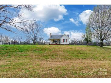 Charming exterior view of a quaint single story home on a sprawling green lot under a bright blue sky at 2455 Wellridge Rd, Chester, SC 29706
