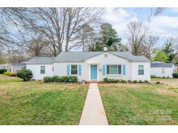 Charming single story home with walkway, blue shutters, neutral paint and lush front yard at 3036 Marlowe Ave, Charlotte, NC 28208