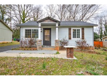Charming single-story home featuring stone-accented porch columns and beautifully landscaped front yard at 3901 Durham Ln, Charlotte, NC 28269