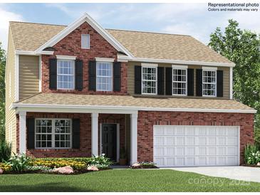 New construction two-story home with brick facade, 2-car garage, and manicured lawn at 5710 Olive Beach Rd, Kannapolis, NC 28081