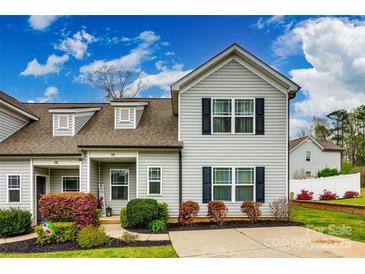 Charming two-story home with a well-manicured lawn, beautiful landscaping, and a private driveway at 730 Shuttles Way, Fort Mill, SC 29715