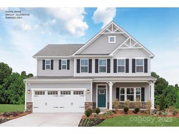 Charming two-story home with gray siding, white trim, black shutters and a two-car garage at 1240 Cottage Green Dr # 0132, Monroe, NC 28112