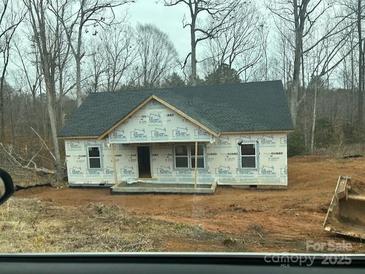 Unfinished exterior of single story home with dark grey roof, porch, and yard under construction at 1475 32Nd Sw St, Hickory, NC 28602
