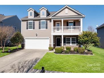 Charming two-story home with a welcoming front porch and well-manicured lawn at 79357 Ridgehaven Rd, Lancaster, SC 29720