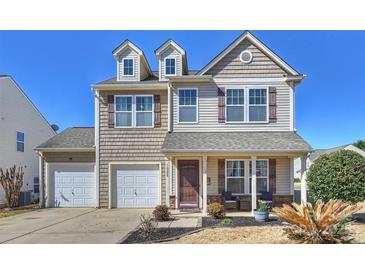 Charming two-story home boasts a welcoming front porch and a two-car garage at 1008 Newton Ave, Rock Hill, SC 29732
