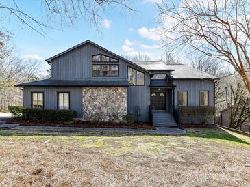 Charming two-story home featuring a stone facade and professionally landscaped front yard at 13424 Portside Ct, Charlotte, NC 28278