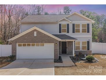 Two-story home with a brick garage, gray siding, black shutters, and a well-maintained front yard at 205 Athens Dr # 31, Salisbury, NC 28147