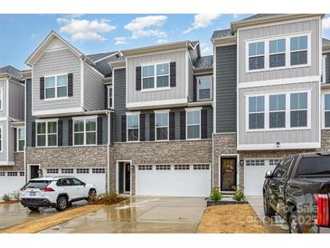 Stylish townhome features gray siding, stone accents, and a two-car garage at 2061 Dornoch Rd, Fort Mill, SC 29708