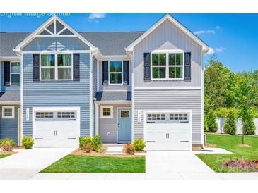 Charming townhome exterior with a one car garage, manicured lawn, and beautiful, contemporary curb appeal at 2061 Stephens Farm Dr, China Grove, NC 28023
