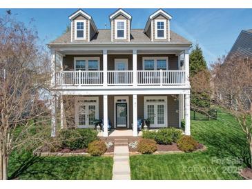 Charming two-story home boasts a welcoming front porch, detailed trim, and lush landscaping at 371 Montibello Dr, Mooresville, NC 28117