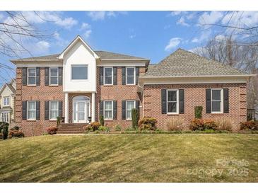Two-story brick home with a manicured lawn and mature trees at 4421 3Rd Nw St, Hickory, NC 28601