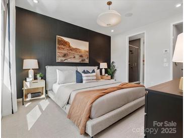 A stylish bedroom with a statement wall, plush bedding, and a calming desert landscape art piece at 5640 Kingspan Dr, Charlotte, NC 28217