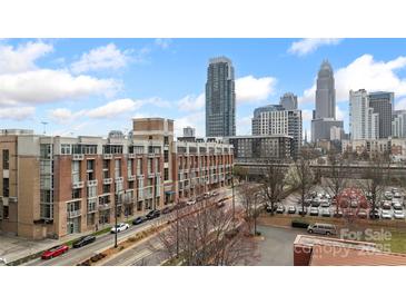 Brick apartment building with city skyline views on a sunny day at 710 W Trade St # 309, Charlotte, NC 28202