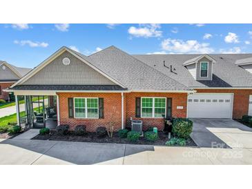 Charming brick home with a well-manicured lawn, black shutters, and an attached garage at 8146 Viscount Ct, Denver, NC 28037