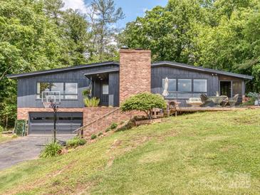 Charming two-story home with a brick chimney, gray paint and a well-manicured lawn at 109 Joe Teague Rd, Hickory, NC 28601