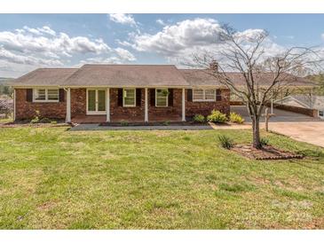 Charming brick home featuring a covered porch and well-maintained front yard at 114 Joe Teague Rd, Hickory, NC 28601