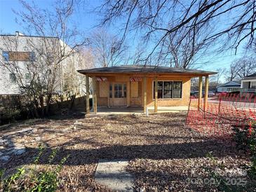 Exterior elevation of a small house under construction, featuring a covered porch and visible framework at 1600 Julia Maulden Pl, Charlotte, NC 28206