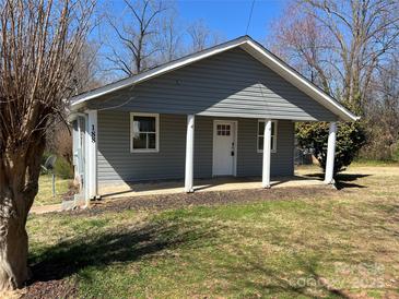 Charming single-story home featuring a covered front porch with classic white columns and gray siding at 188 13Th Se St, Hickory, NC 28602